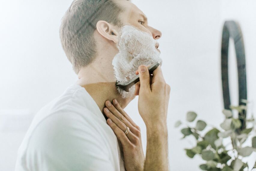 Man shaving to avoid acne and folliculitis 