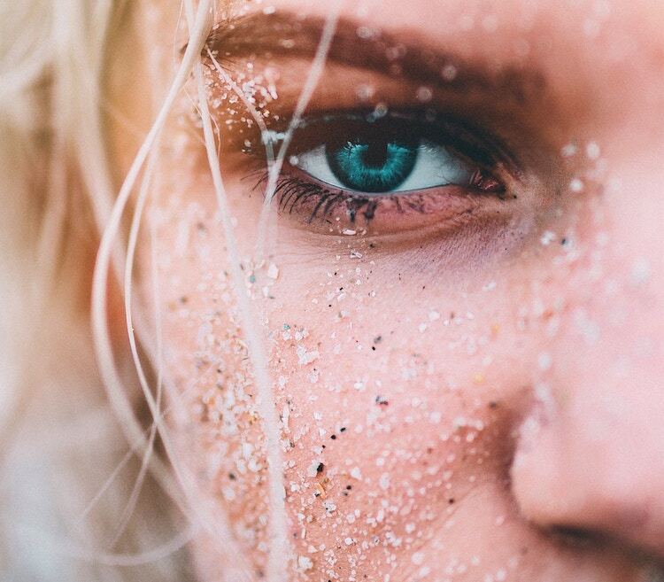 Woman with sand on her face