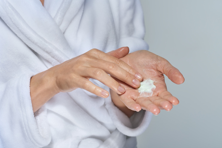 Woman about to apply MDacne oil-free moisturizer