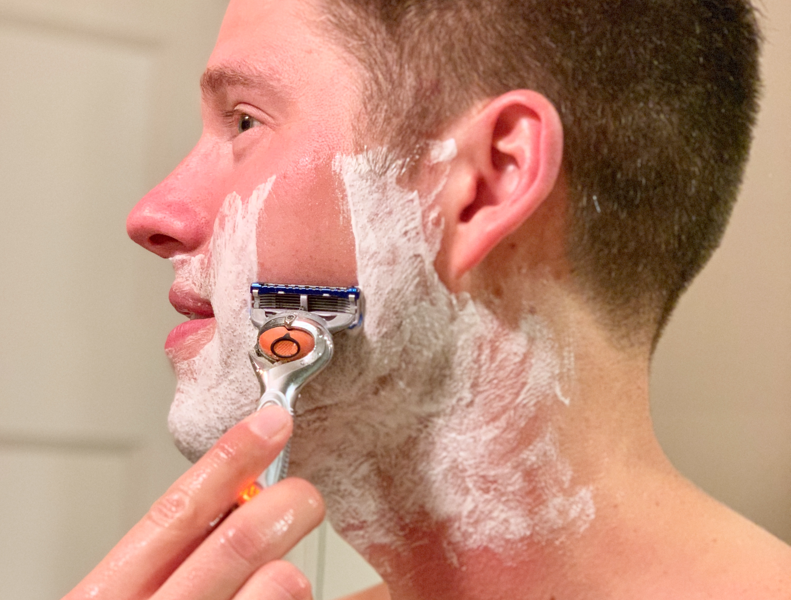 Man shaving with Gilette Mach 3 razor