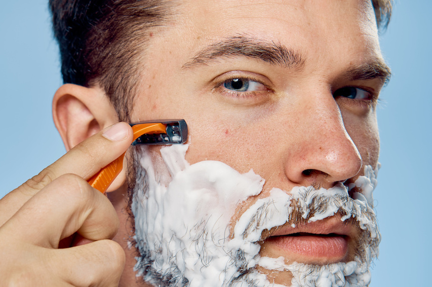 Man shaving with MDacne Soothing Shave Cream