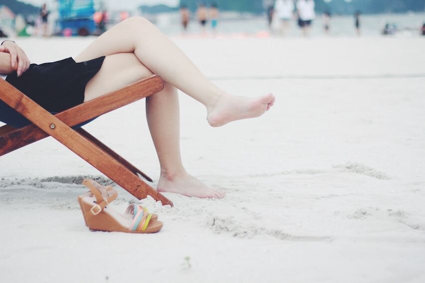 Woman on beach with smooth shaved legs without razor bumps