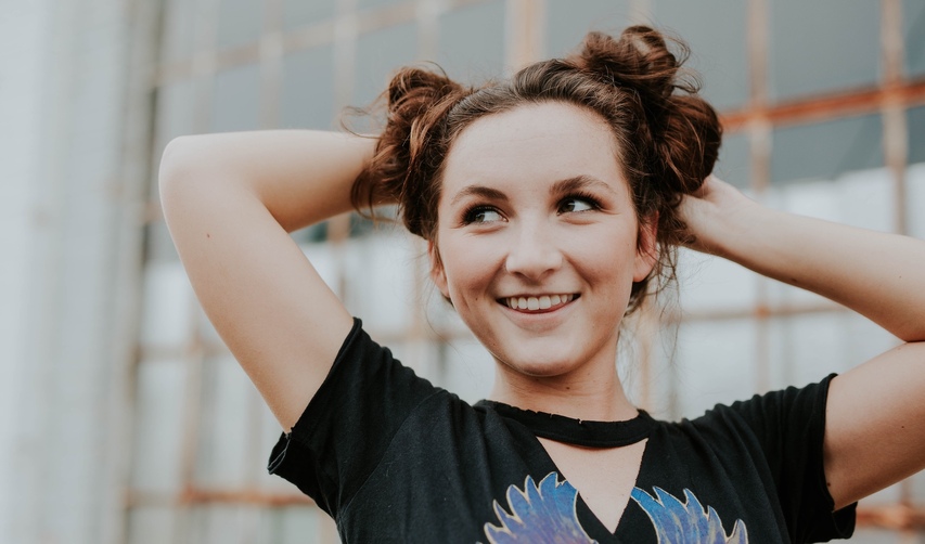 girl with acne making face burn